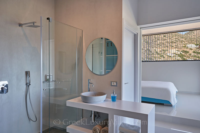 Modernes Schlafzimmer mit eigener Dusche in der Luxusvilla mit beheiztem Pool in Elounda