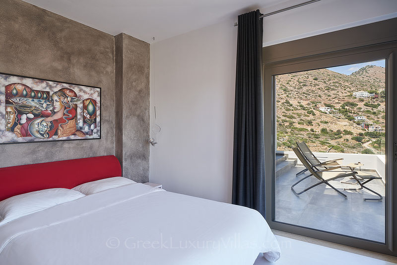 Schlafzimmer der modernen Luxusvilla mit beheiztem Pool und Blick auf die Bucht von Elounda