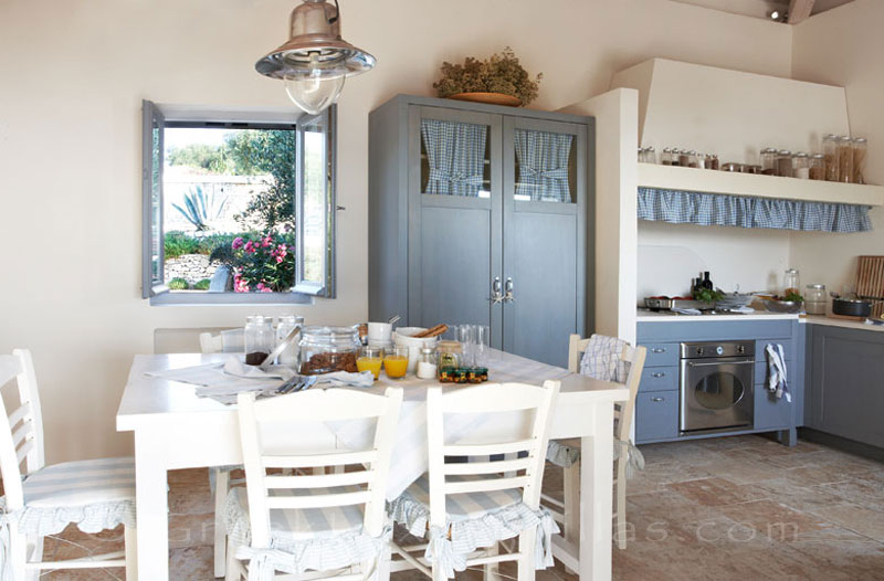 The kitchen and the dining area of a beachfront villa with a pool in Paxos