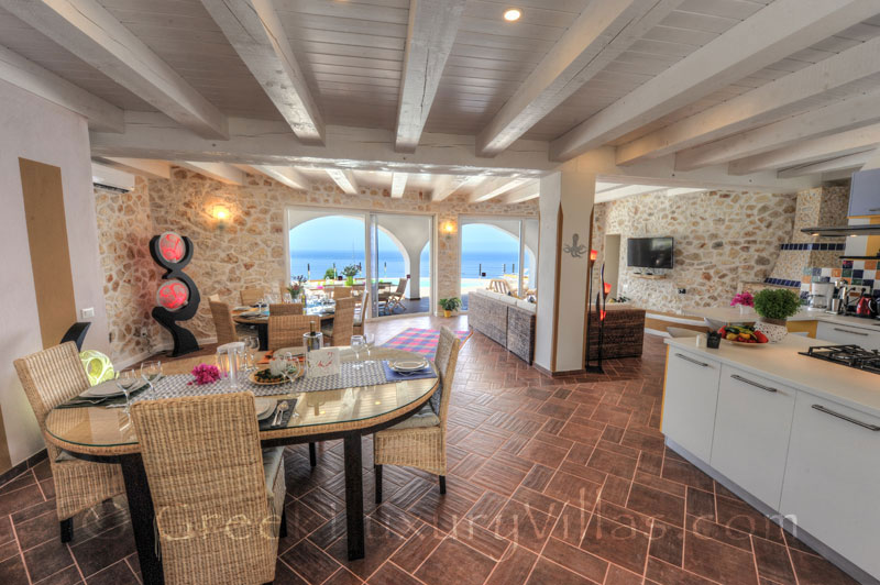 The living-room of the cheerfully decorated villa with a pool and seaview in Paxos