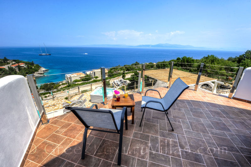 The balcony of a villa with a pool and seaview in Paxos