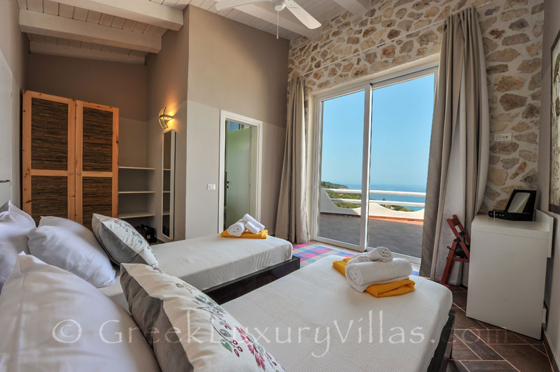 A bedroom of the villa with a pool and seaview in Paxos