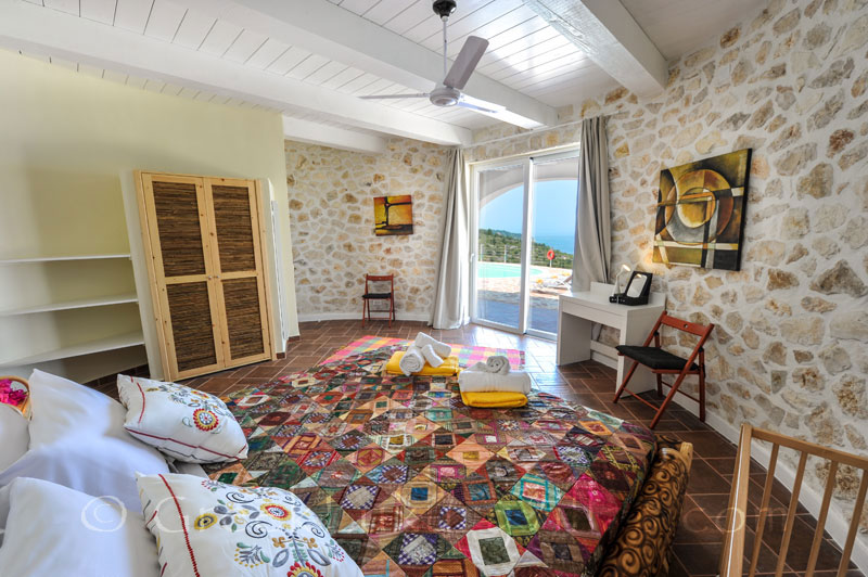 A cheerful bedroom with sea view in a villa with a pool in Paxos