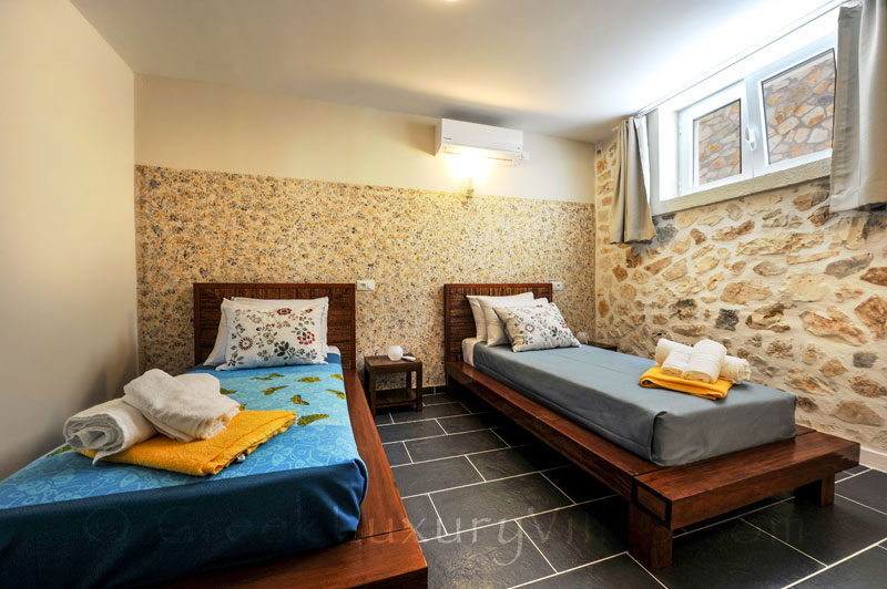 A bedroom with seaview in a cheerfully decorated villa with a pool in Paxos