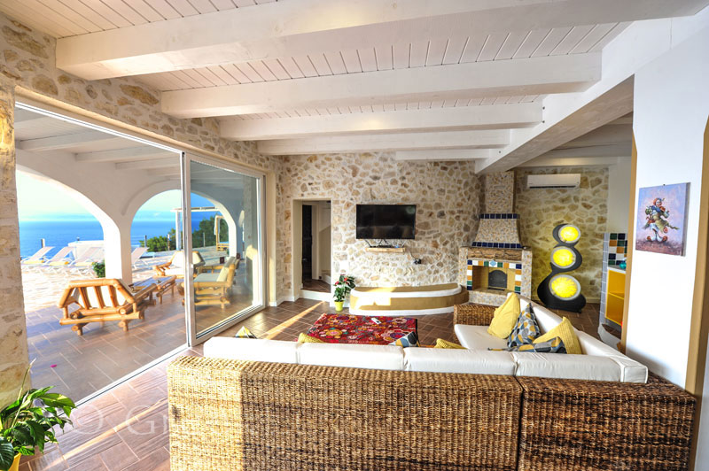 The living-room of a cheerfully decorated villa with a pool and seaview in Paxos