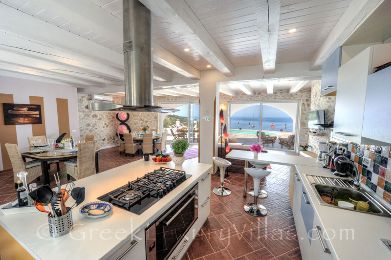 The kitchen of a cheerfully decorated villa with a pool and seaview in Paxos