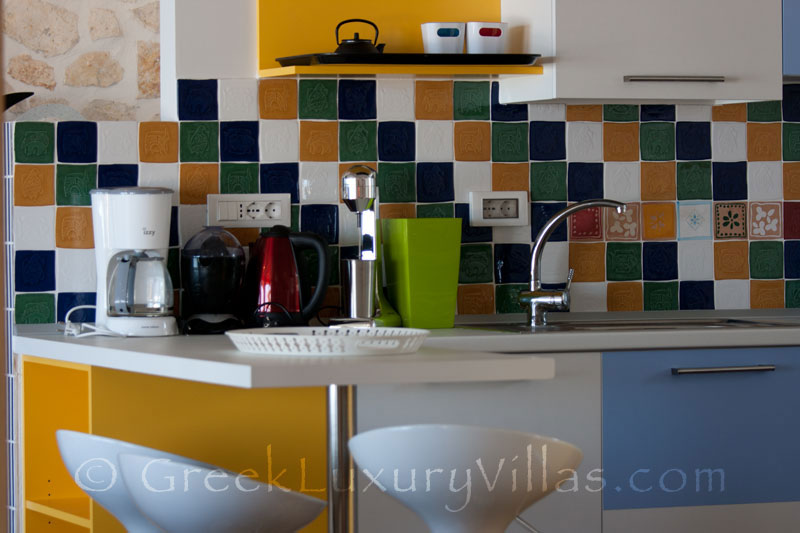 The kitchen in a cheerfully decorated villa with a pool and seaview in Paxos