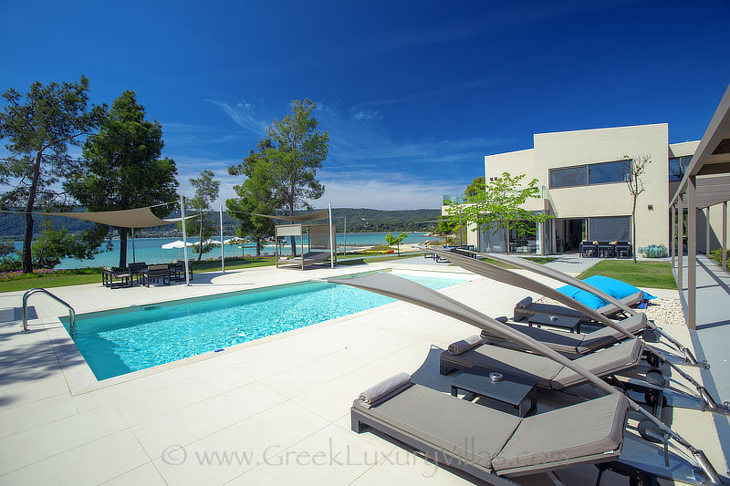 modern beachfront villa pool sun beds