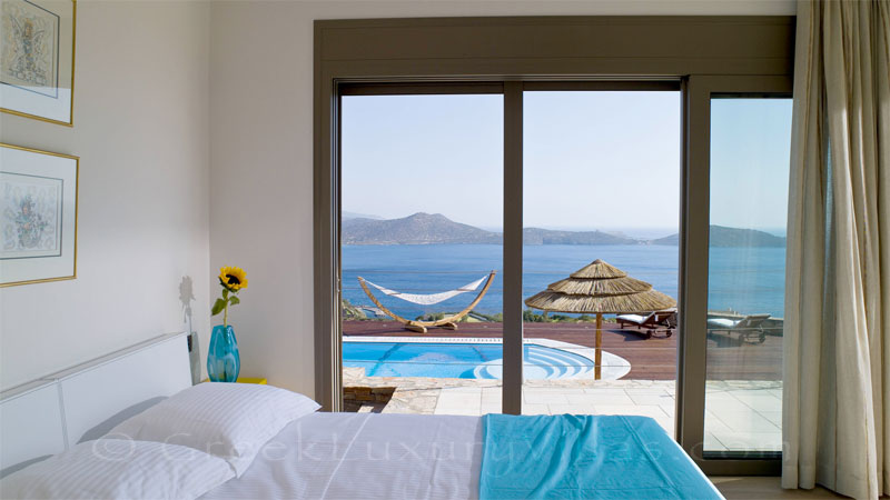 A bedroom in the modern luxury villa with a pool