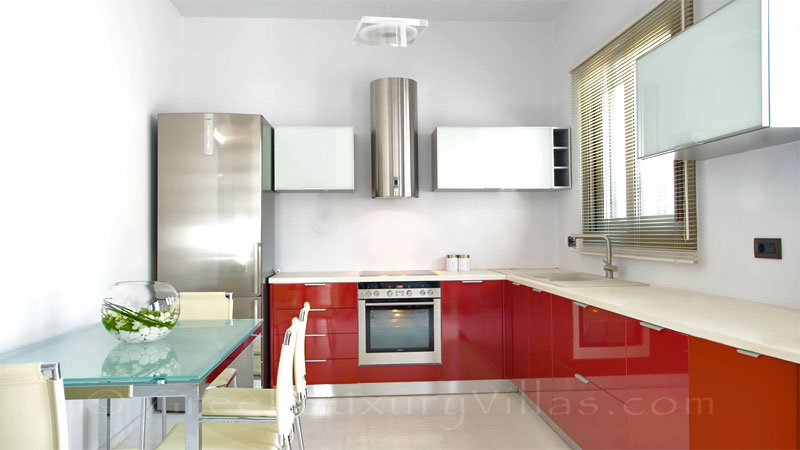 The kitchen of the guest house of a modern luxury villa with a pool