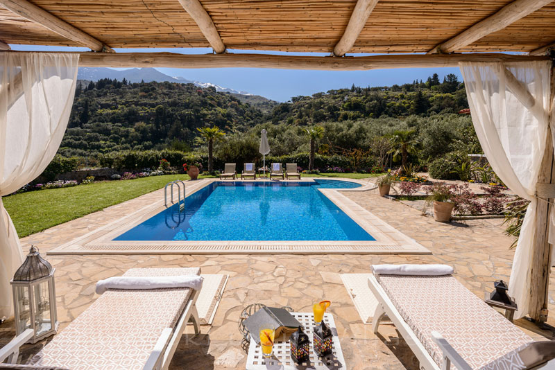 Sun bathing by the pool of luxury villa in Crete