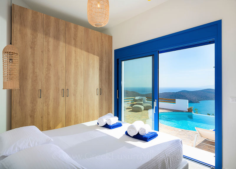 modern bedroom with sea view and pool at luxury villa, Crete