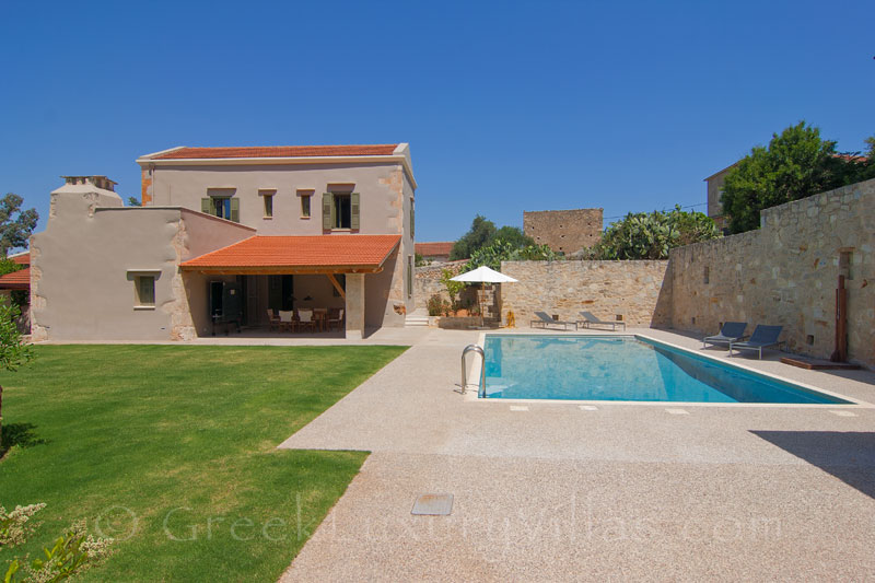 The pool and the garden of a luxury villa with a pool in a traditional village