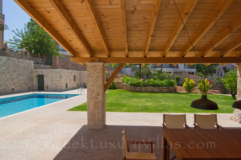 Dining area of a luxury villa with a pool in a traditional village