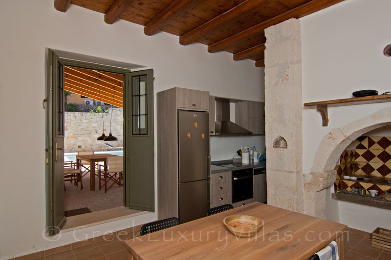 The kitchen of a luxury villa with a pool in a traditional village