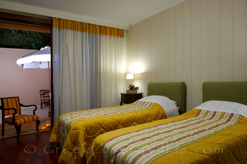 Bedroom with two single beds of traditional cretan style seafront villa in Almyrida Crete