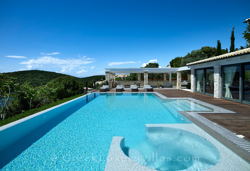 The heated pool and the jacuzzi of a luxury villa in Sivota
