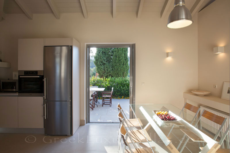 The kitchen of a modern luxury villa with a pool in Lefkada