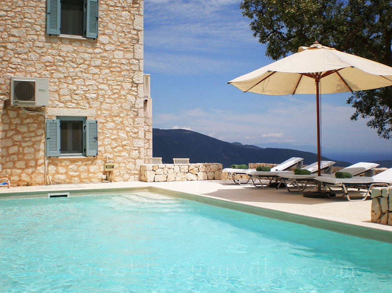 Sunbeds at a villa with a pool and sea view in Lefkada
