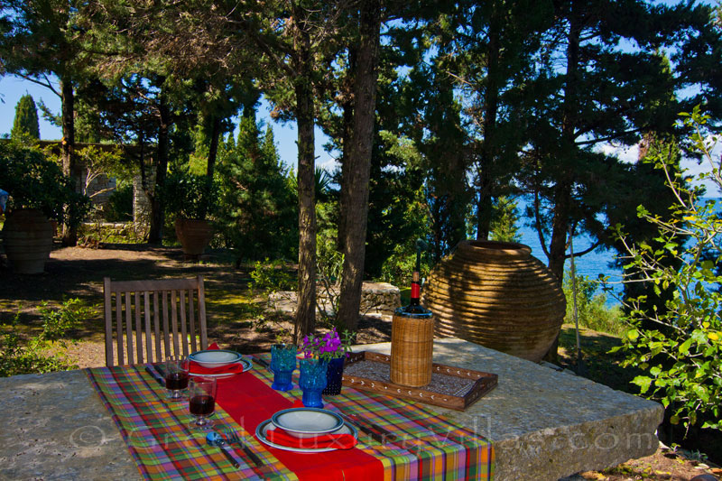 The dining table in the garden of a beachfront villa in Paxos