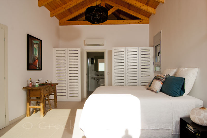 A bedroom with seaview in a modern luxury villa with a pool in Paxos