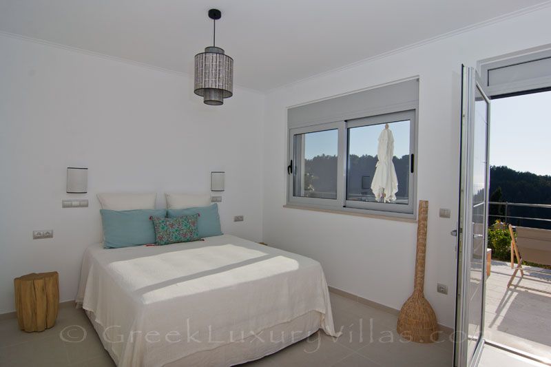 The bedroom with seaview of the guesthouse of the modern luxury villa with a pool in Paxos