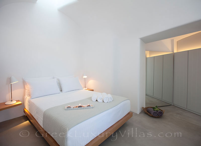 A bedroom of a contemorary luxury villa in Santorini