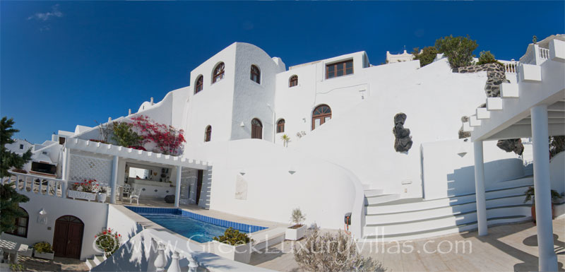 A large villa with a pool on the cliff of Santorini