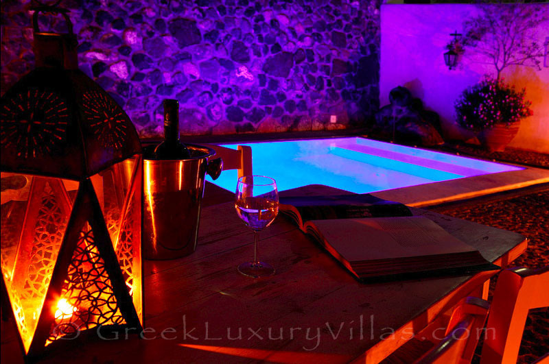 Night atmosphere at the pool of a stone house villa for two in Santorini