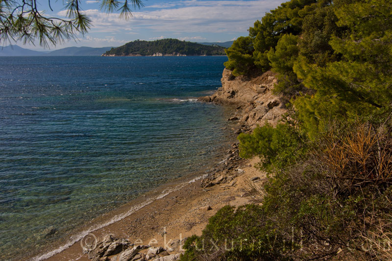 A walk at the private beach of beachfront cottage on Skiathos