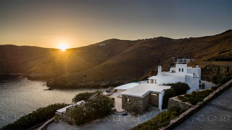 sunset over big luxury pool villa Syros Greece