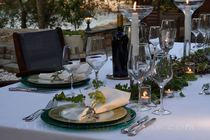 dinner table at waterfront luxury villa with private chef butler boat