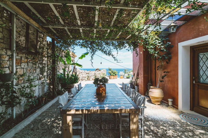 Outdoor dining area with a pergola at a villa in Zakynthos